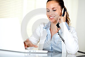 Smiling young woman conversing on phone