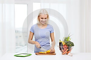 Smiling young woman cooking vegetables at home