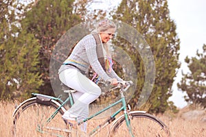 Smiling young woman cycling