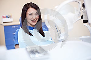 Smiling young woman in dental office