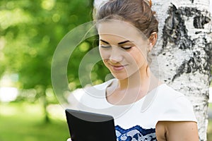 Smiling young woman with digital tablet