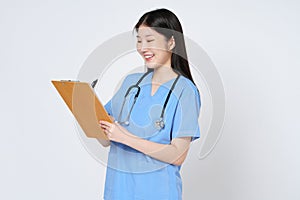 Smiling young woman doctor taking notes making medical with clipboard isolate over white background