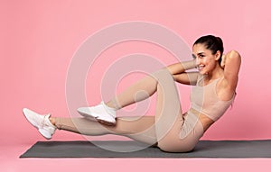 Smiling Young Woman Doing Abs Exercise, Side Crunches