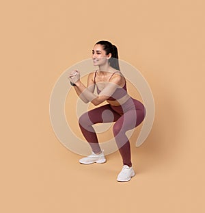 Smiling Young Woman Doing Deep Squat Exercise
