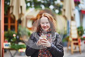 Woman drinking hot red wine on a Christmas market