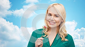 Smiling young woman eating vegetable salad