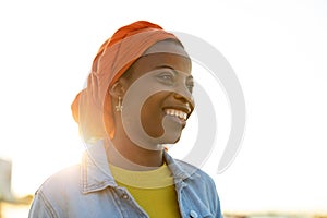 Smiling young woman enjoying the outdoors at sunset