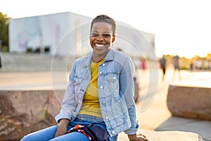 Smiling young woman enjoying the outdoors at sunset