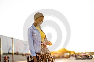 Smiling young woman enjoying the outdoors at sunset