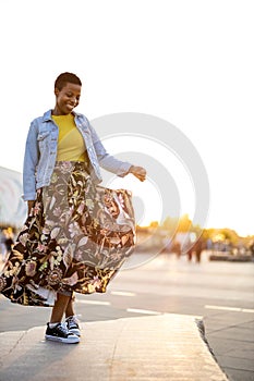 Smiling young woman enjoying the outdoors at sunset