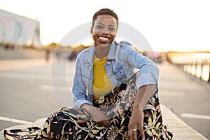 Smiling young woman enjoying the outdoors at sunset