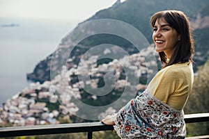 Smiling young woman enoying seaview in Positano,Italy. Vacation on Amalfi coast.Happy tourist in Europe.Italian coast beauty,