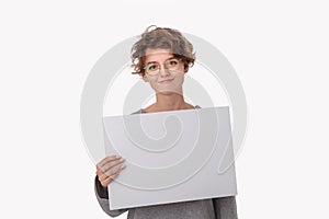 Smiling young woman with eyeglass holding empty blank paper board with copy space for text. photo