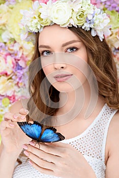 smiling young woman in floral wreath with butterfly photo