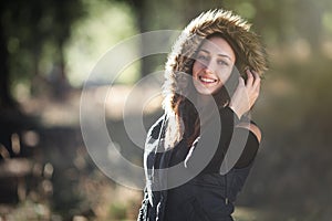 Smiling young woman in the forest
