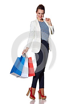 Smiling young woman with French flag colours shopping bags