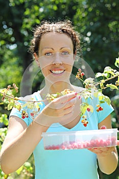 A smiling young woman gathering