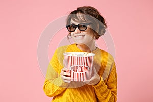 Smiling young woman girl in 3d imax glasses posing isolated on pink background. People sincere emotions in cinema photo