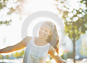 Smiling young woman having fun in city park