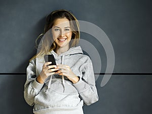 Smiling young woman with her cellphone