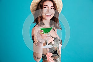 Smiling young woman holding cocktail