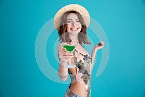 Smiling young woman holding cocktail