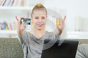 Smiling young woman holding credit cards