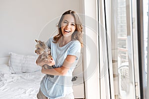 Smiling young woman holding dog