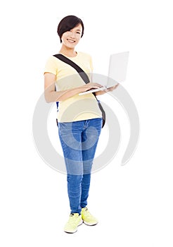 Smiling young woman holding a laptop and isolated on white