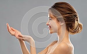 Smiling young woman holding something imaginary