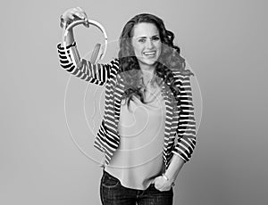 Smiling young woman isolated on showing headphones