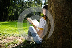 Young Woman Reading Park View from Behind