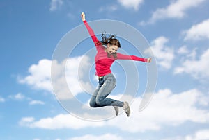 Smiling young woman jumping in air