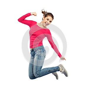 Smiling young woman jumping in air