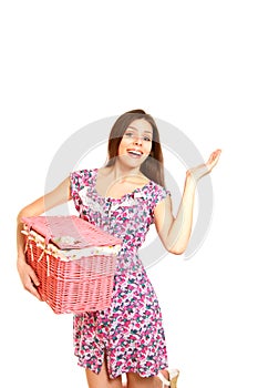 Smiling young woman with a laundry basket on white background
