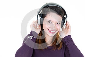 Smiling young woman listening music wireless headphones on ear smiling and happiness