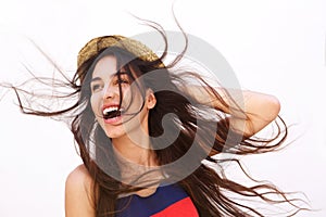 Smiling young woman with long hair blowing in the wind