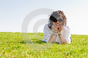 Smiling young woman lying on the grass