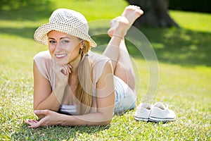 Smiling young woman lying on grass