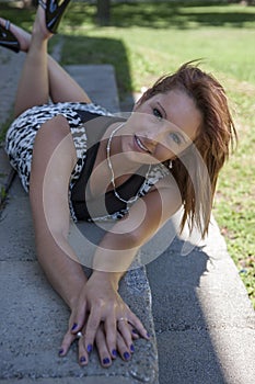 Smiling young woman lying outdoors