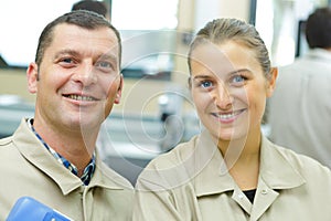 smiling young woman and man in storehouse photo
