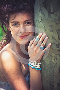 Smiling young woman nature lover relax on summer day hug a tree