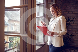 Young woman in office contacting business partner