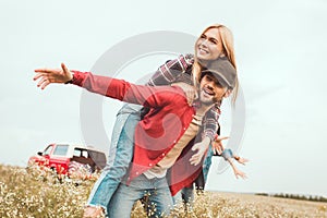 smiling young woman piggybacking on boyfriend