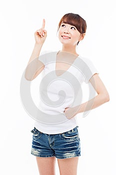 Smiling young woman pointing upwards