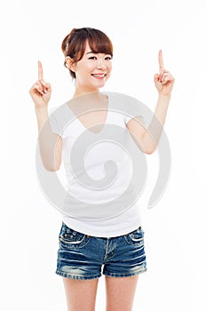 Smiling young woman pointing upwards