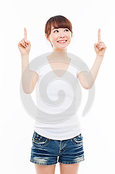 Smiling young woman pointing upwards