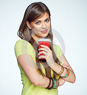 Smiling young woman posing on white background with coffee cup.