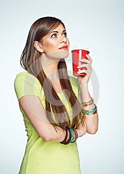 Smiling young woman posing on white background with coffee cup.
