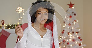 Smiling young woman in a Santa Claus cloak